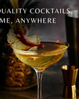 Cocktail in a glass with decorative elements on a bar counter, accompanied by text 'Bar-quality cocktails, anytime, anywhere'.