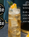 Cocktail with pineapple garnish and Great Taste awards on a dark background
